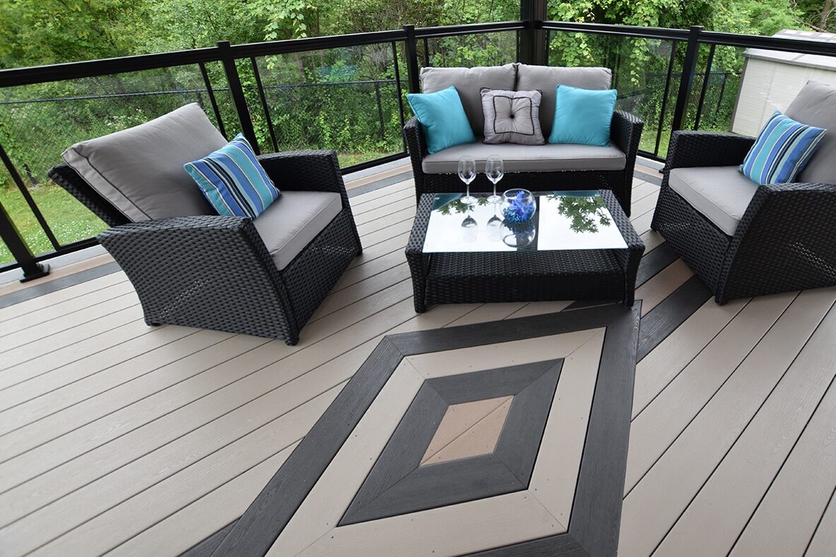 8x10 vinyl deck with diamond design featuring black brown and tan vinyl decking as well as three chairs and table for seating