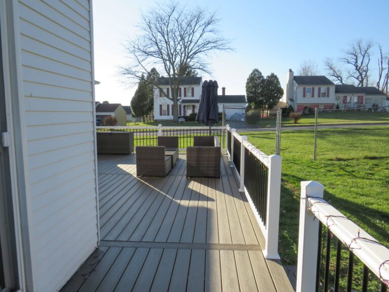 a beige deck on the side of a white house in york pa