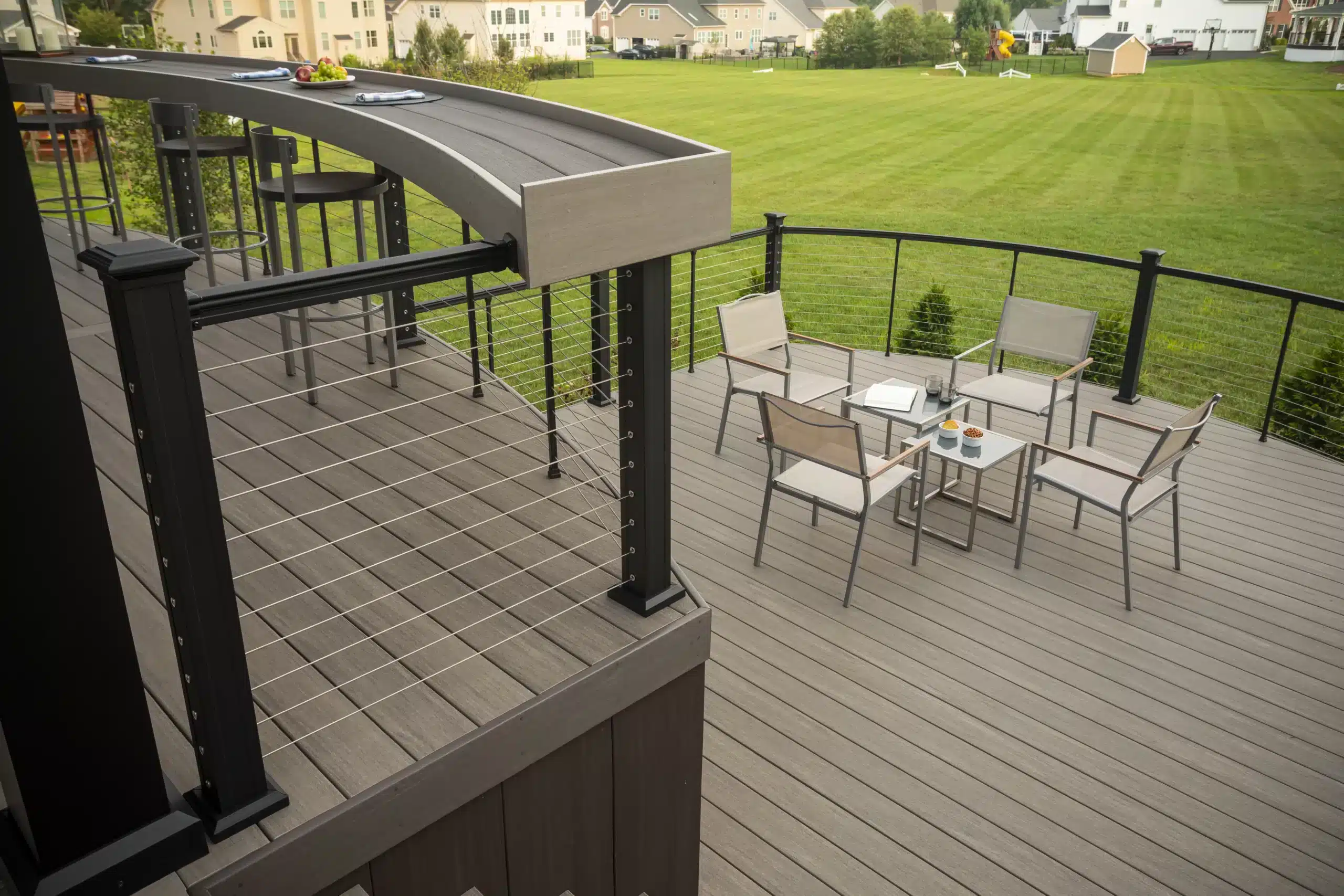 a multi-level brown deck with a table and chairs on the lower level in york pa