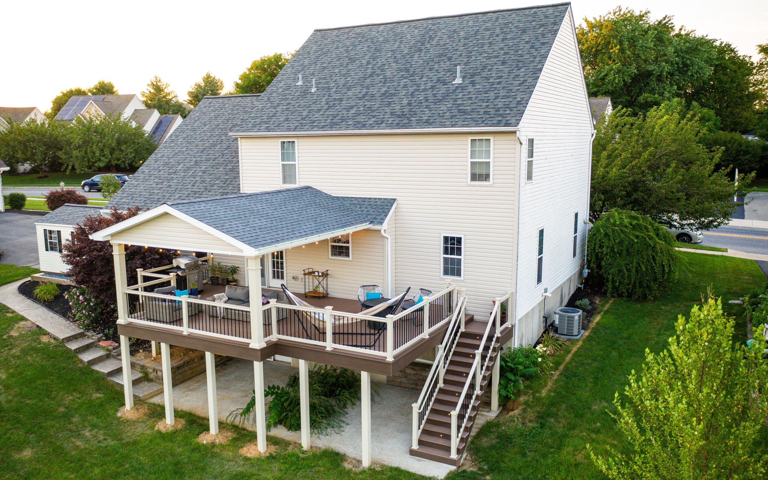 an elevated deck attached to the back of a white house in york pa