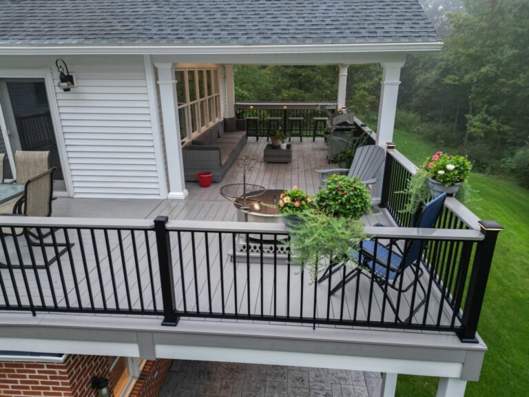 an elevated deck with a black railing attached to a white house in york pa