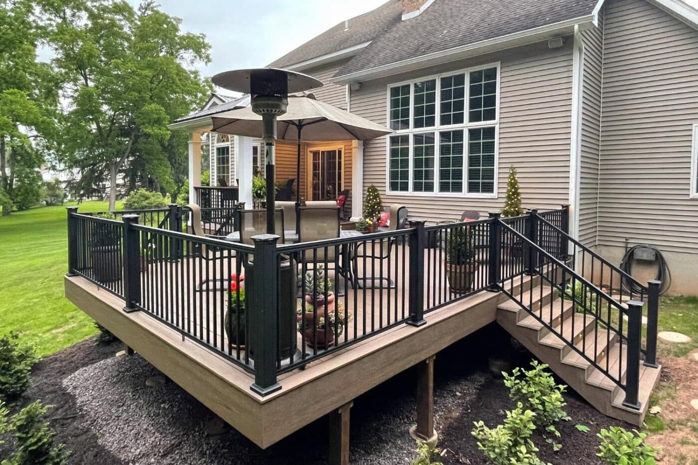 Upper Dauphin Vinyl Products railing on deck with view of seating area and heat lamp