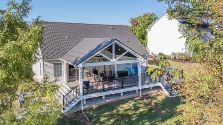 deck with pavilion and large set of steps down to a patio