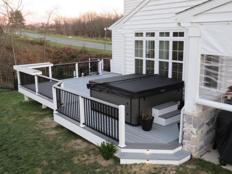 A grey deck with a hot tub on it and lights built into the stairs in Lebanon PA