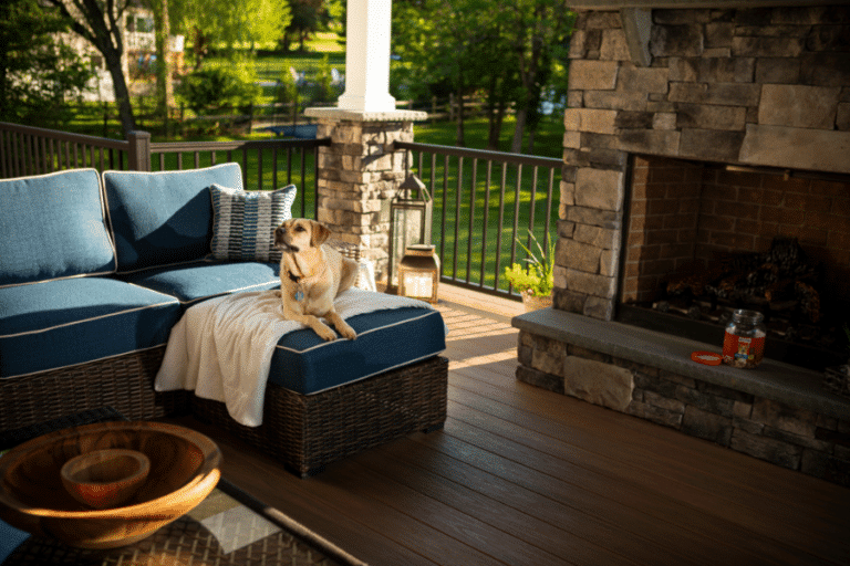 dog sitting on blue porch seating on composite wood deck with fireplace