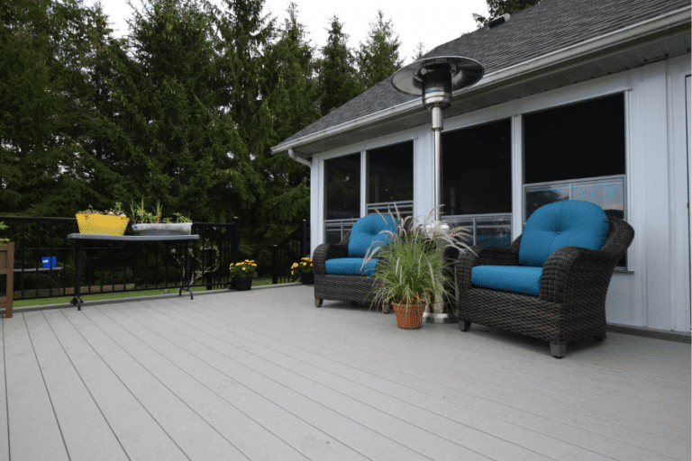 gray vinyl decking on back deck with two chairs and some plants