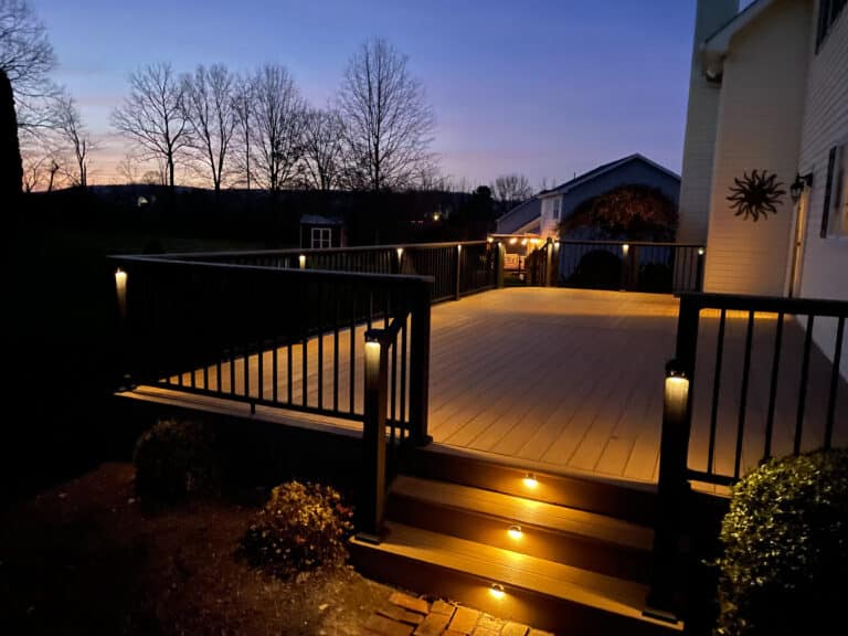 lights built into steps of 8x10 deck with black railings at night