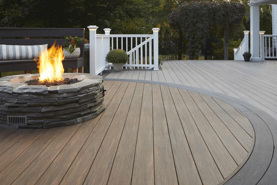 timbertech composite decking with lights gray and dark brown circle decking pattern around fireplace with lighter brown decking inside