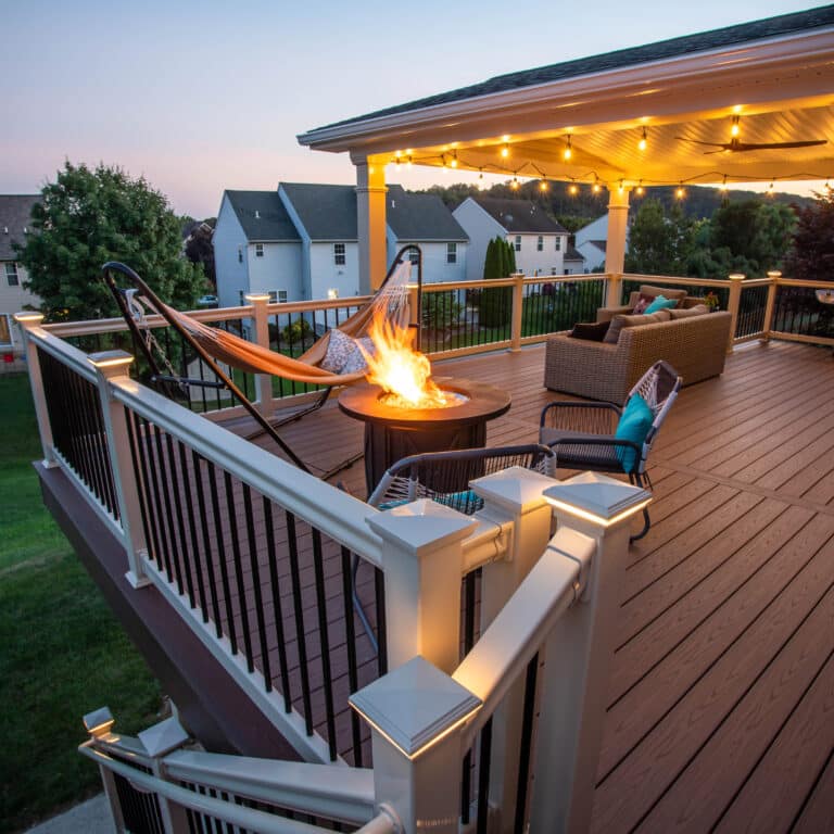 wood composite 8x10 deck with string lights hammock and seating area around fire pit